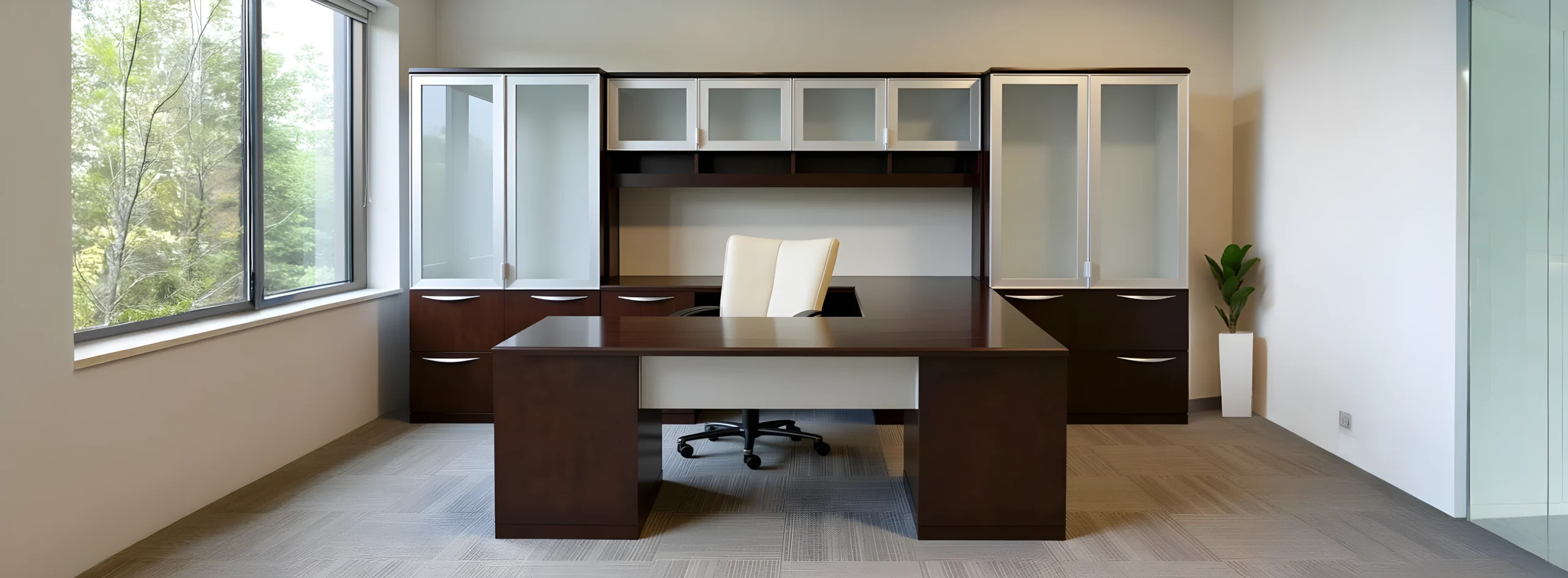 Spacious office with a large, dark wooden desk and white chair